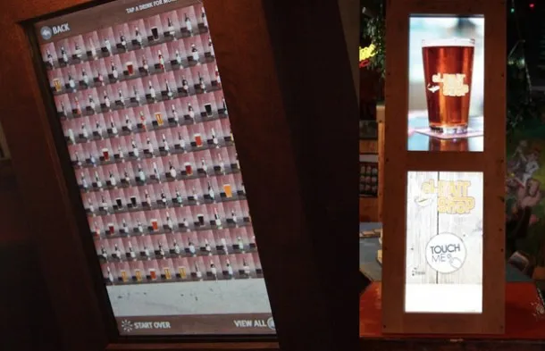 The full selection as a touchable wall, and the attract screen on the pedestal.